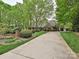 Traditional brick home with stately curb appeal, lush landscaping, and long driveway at 1126 Concord Rd, Davidson, NC 28036
