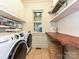Well-appointed laundry room with modern washer, dryer, ample shelving, and counter space at 1126 Concord Rd, Davidson, NC 28036
