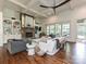 Cozy living room featuring a stone fireplace, coffered ceilings, and ample natural light from large windows at 1126 Concord Rd, Davidson, NC 28036