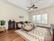 Spacious main bedroom featuring a ceiling fan, area rug, hardwood floors, and natural light at 1126 Concord Rd, Davidson, NC 28036