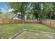 Grassy backyard with a wooden fence, mature trees, and green grass at 113 Mcgill Nw Ave, Concord, NC 28025
