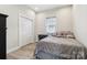 Cozy bedroom with hardwood floors, closet, window, and stylish furniture at 113 Mcgill Nw Ave, Concord, NC 28025