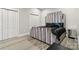Stylish bedroom featuring a modern bed, luxury vinyl flooring, and ample closet space at 113 Mcgill Nw Ave, Concord, NC 28025