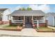 Charming single-story home with a cozy front porch and well-maintained landscaping at 113 Mcgill Nw Ave, Concord, NC 28025