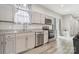 Modern kitchen featuring stone countertops, stainless steel appliances, and luxury vinyl flooring at 113 Mcgill Nw Ave, Concord, NC 28025