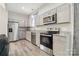 Updated kitchen with stainless steel appliances, granite countertops, and luxury vinyl flooring at 113 Mcgill Nw Ave, Concord, NC 28025