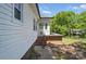 A back door of a house with a small porch and steps leading to the yard at 113 S College St, Monroe, NC 28112
