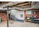 Spacious basement with brick wall, concrete floor, stairs, and utility access at 113 S College St, Monroe, NC 28112