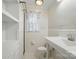 Bathroom with tile flooring, toilet, sink, and shower featuring a white and floral curtain at 113 S College St, Monroe, NC 28112