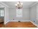 Dining room with hardwood floors and traditional chandelier at 113 S College St, Monroe, NC 28112