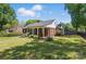 Spacious brick home featuring a well-manicured lawn and a welcoming covered porch at 113 S College St, Monroe, NC 28112