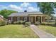 Charming brick home with a well-maintained front lawn and covered porch, exuding curb appeal at 113 S College St, Monroe, NC 28112