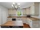 Kitchen with white cabinets and wood island at 113 S College St, Monroe, NC 28112
