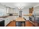 Kitchen with white cabinets and wood island at 113 S College St, Monroe, NC 28112