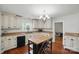 Kitchen with white cabinets and wood island at 113 S College St, Monroe, NC 28112