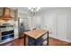 Bright eat-in kitchen with stainless steel appliances and a charming light fixture at 113 S College St, Monroe, NC 28112