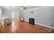 Bright living room with hardwood floors, a fireplace, and ample natural light at 113 S College St, Monroe, NC 28112