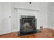 Living room with a fireplace with white mantel and tiled hearth at 113 S College St, Monroe, NC 28112