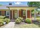 Inviting covered porch with brick flooring and a ceiling fan, perfect for relaxation at 113 S College St, Monroe, NC 28112