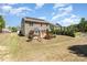 View of back of home with solar panels, backyard with patio, playset, and mature trees at 1176 Shiloh Bend Trl, Fort Mill, SC 29715