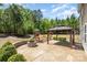 Backyard featuring a covered patio, fire pit, playset, and mature trees at 1176 Shiloh Bend Trl, Fort Mill, SC 29715