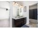 Bathroom with double vanity and entryways to a bedroom and bathroom at 1176 Shiloh Bend Trl, Fort Mill, SC 29715