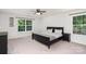 Spacious bedroom with two bright windows, ceiling fan, and large black bed frame at 1176 Shiloh Bend Trl, Fort Mill, SC 29715