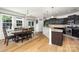 Dining area and kitchen featuring dark cabinetry and modern appliances at 1176 Shiloh Bend Trl, Fort Mill, SC 29715