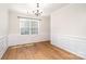 Elegant dining room featuring hardwood floors, wainscoting, and a chandelier at 1176 Shiloh Bend Trl, Fort Mill, SC 29715