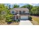 Inviting two-story home with a manicured lawn, stone accents, and a two-car garage at 1176 Shiloh Bend Trl, Fort Mill, SC 29715