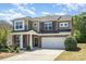 This is a beautiful home with brick and stone accents, an attached garage, and a manicured lawn at 1176 Shiloh Bend Trl, Fort Mill, SC 29715