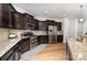Well-appointed kitchen featuring dark cabinets, granite countertops, and stainless steel appliances at 1176 Shiloh Bend Trl, Fort Mill, SC 29715