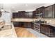Stylish kitchen with dark cabinetry, stainless steel appliances, and granite counters at 1176 Shiloh Bend Trl, Fort Mill, SC 29715