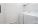 Bright laundry room with side-by-side washer and dryer and overhead storage shelf at 1176 Shiloh Bend Trl, Fort Mill, SC 29715