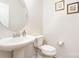 Classic powder room featuring a pedestal sink, toilet, oval mirror, and neutral wall color at 1176 Shiloh Bend Trl, Fort Mill, SC 29715