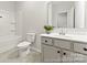 Bright bathroom with a shower-tub combo, large mirror, and a decorative potted plant at 1194 Links Crossing Dr # 163P, Monroe, NC 28112