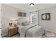 Comfortable bedroom with large window, side tables, and neutral tones at 1198 Links Crossing Dr # 162P, Monroe, NC 28112