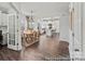 Dining room featuring a wooden table with seating for six, dark wood floors, and a view into the kitchen at 1198 Links Crossing Dr # 162P, Monroe, NC 28112