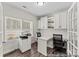Bright home office space featuring built-in cabinets, dual workstations, natural light, and wood floors at 1198 Links Crossing Dr # 162P, Monroe, NC 28112