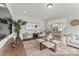 Bright living room featuring hardwood floors, stylish furnishings, and an open layout connected to the kitchen at 1198 Links Crossing Dr # 162P, Monroe, NC 28112