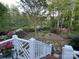 Tranquil backyard showcasing colorful azaleas, lush greenery, a stone pathway, and mature trees at 121 General Pemberton St, Stanley, NC 28164