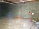 Unfinished basement with block walls and concrete floor, offering potential for customization and additional space at 121 General Pemberton St, Stanley, NC 28164