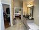 Bathroom with a vanity and mirror, leading to a closet and bedroom, offering a glimpse into the home's layout at 121 General Pemberton St, Stanley, NC 28164