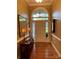 Welcoming foyer with hardwood floors, arched window, and front door at 121 General Pemberton St, Stanley, NC 28164