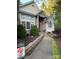Elegant home exterior with stone accents, a welcoming walkway, and beautifully landscaped yard at 121 General Pemberton St, Stanley, NC 28164