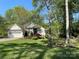 Landscaped front yard and charming exterior of home with attached two-car garage and mature shade trees at 121 General Pemberton St, Stanley, NC 28164