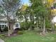 Inviting front yard with lush greenery and trees offering a serene setting for this home at 121 General Pemberton St, Stanley, NC 28164