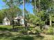 Beautifully landscaped front yard with flowers and trees surrounding a lovely single-Gathering home at 121 General Pemberton St, Stanley, NC 28164
