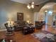Cozy living room with hardwood floors, ceiling fan, and comfortable seating, perfect for relaxation at 121 General Pemberton St, Stanley, NC 28164