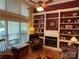 Cozy living room featuring a fireplace with built-in shelves and large windows at 121 General Pemberton St, Stanley, NC 28164